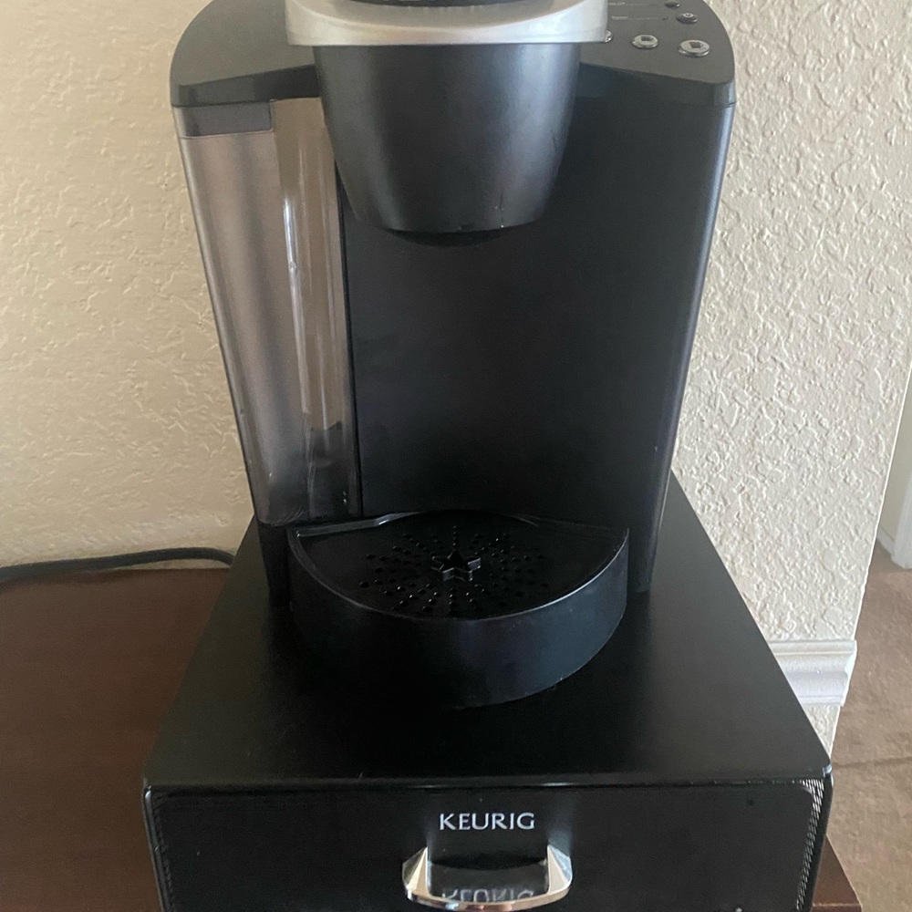 A keurig coffee making with pod storage.